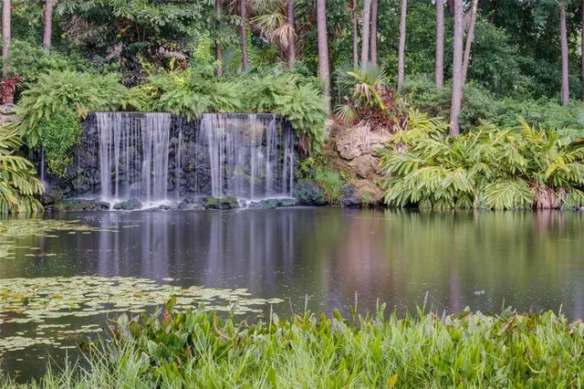 a backyard of a house with lots of green space and lake view