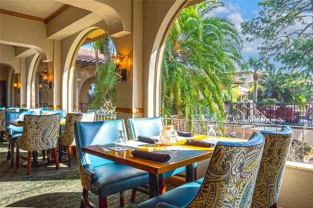 a view of an outdoor dining space with a table and chairs