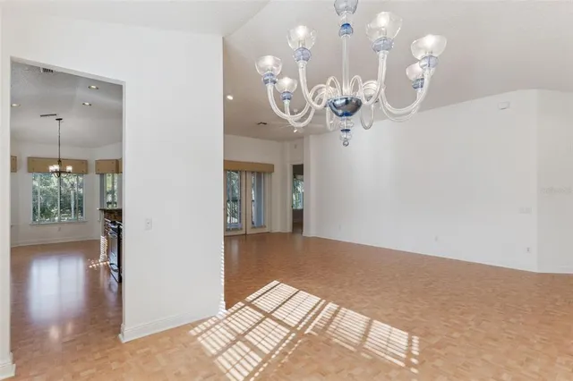 a view of a hallway with chandelier