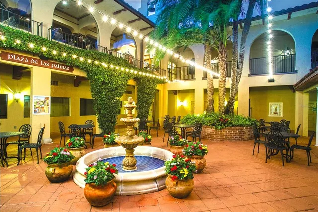 a view of a patio with dining table and chairs potted plants