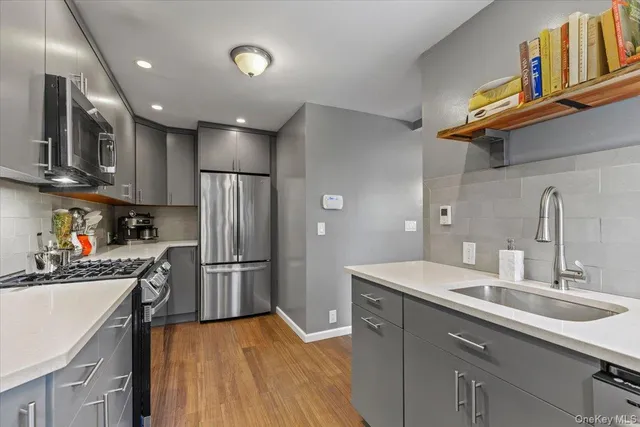 a kitchen with refrigerator cabinets and a sink