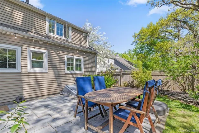 a view of house with a table and chairs in patio