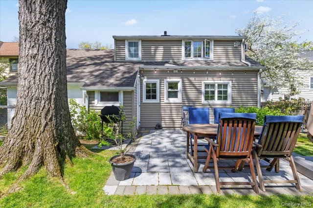 a front view of a house with a yard table and chairs