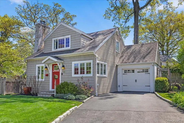 a view of a house with a yard and potted plants