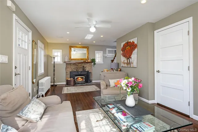 a living room with furniture fireplace and a window