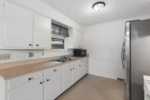 a kitchen with stainless steel appliances a refrigerator and cabinets