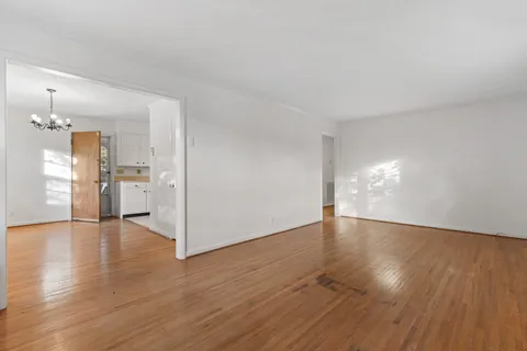 a view of a kitchen with wooden floor and a kitchen