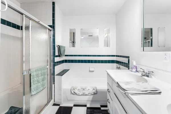 a bathroom with a sink a toilet and shower