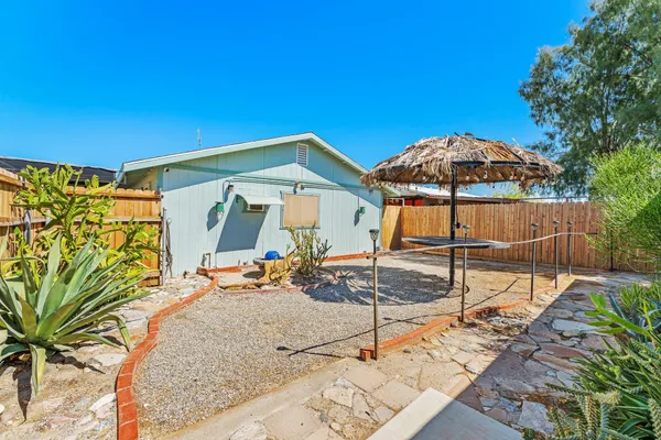 a view of a house with backyard and sitting area