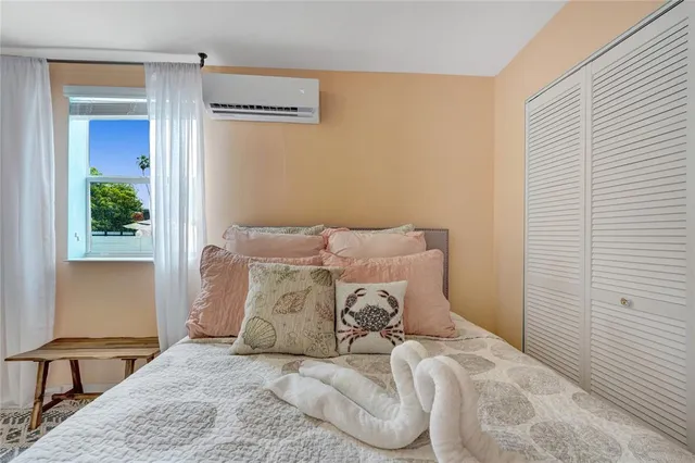 a bed sitting in a bedroom next to a window