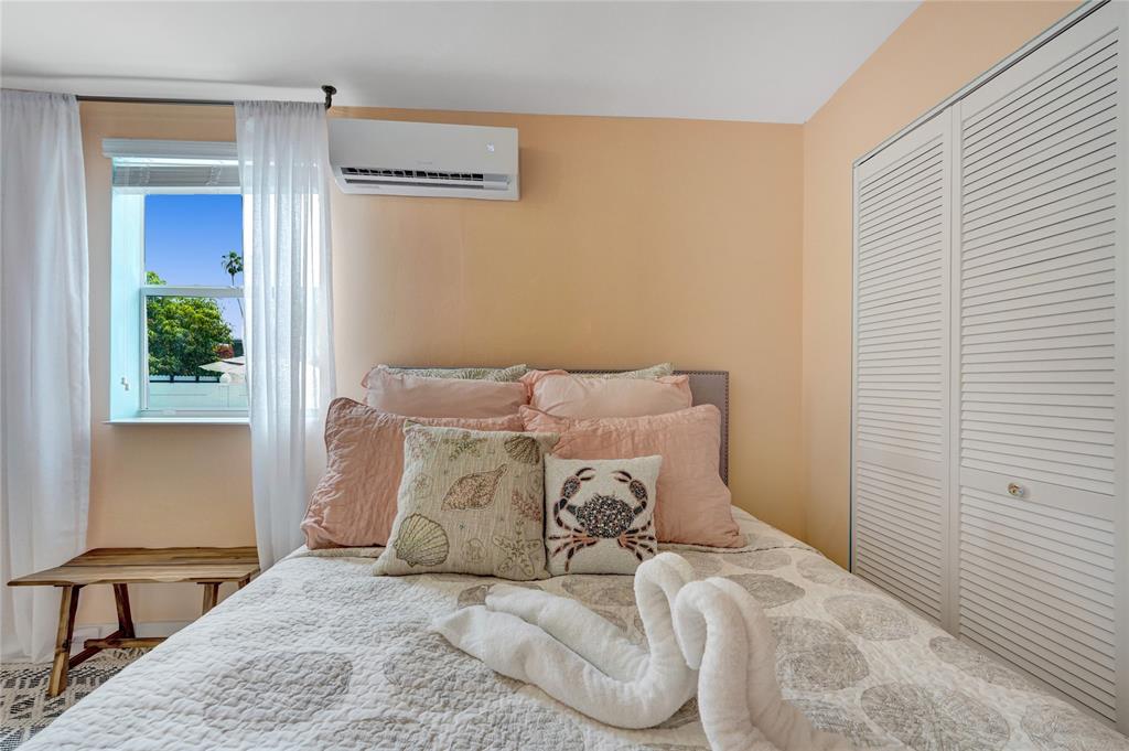 8236 Northwest 1st Place, Unit 2 Miami, FL 33150 - Photo 11 of 21 a bed sitting in a bedroom next to a window