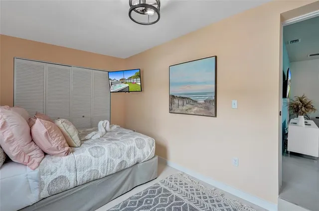 a bedroom with a bed and a painting on the wall