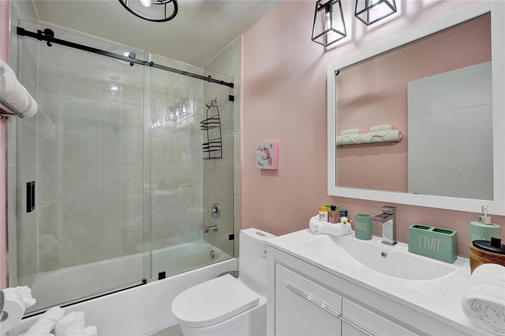 8236 Northwest 1st Place, Unit 2 Miami, FL 33150 - Photo 13 of 21 a bathroom with a bathtub shower sink vanity and toilet