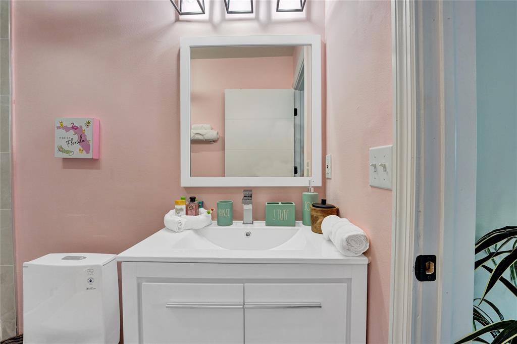 8236 Northwest 1st Place, Unit 2 Miami, FL 33150 - Photo 14 of 21 a bathroom with a sink and a mirror