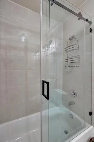 a bathroom with a shower and a bath tub