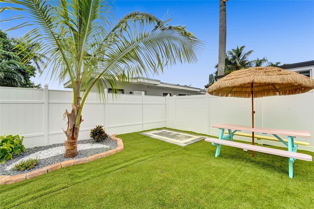 8236 Northwest 1st Place, Unit 2 Miami, FL 33150 - Photo 20 of 21 a backyard of a house with table and chairs