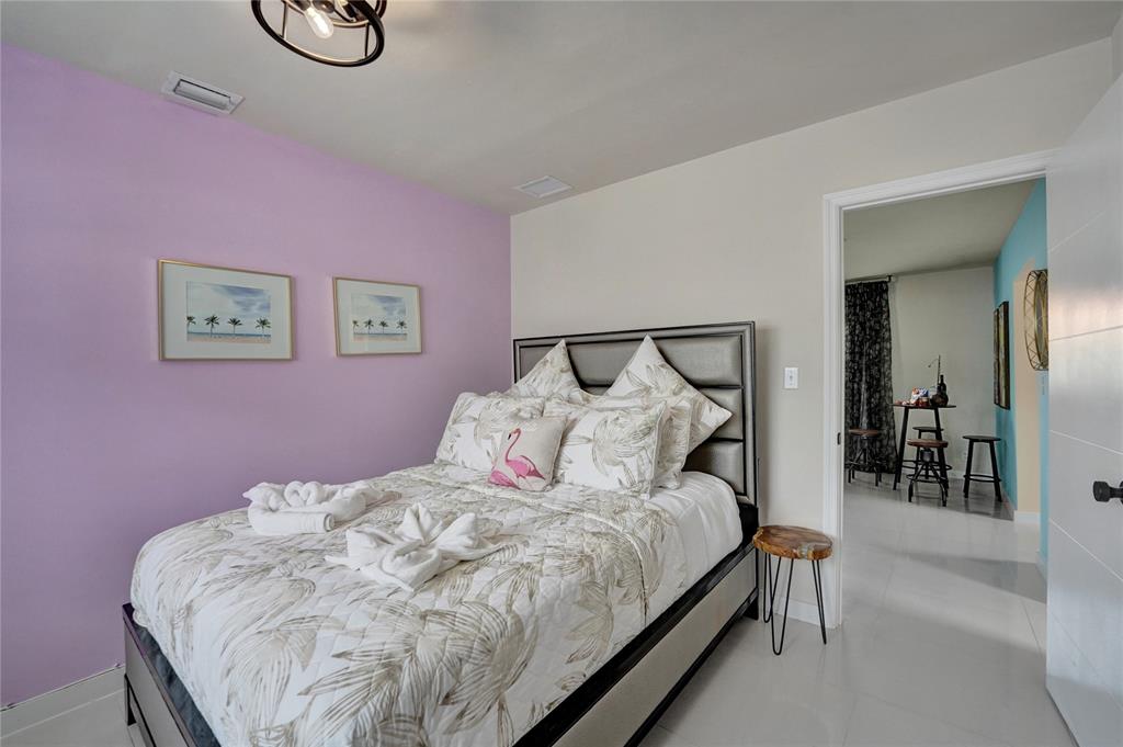 8236 Northwest 1st Place, Unit 2 Miami, FL 33150 - Photo 8 of 21 a bed room with a bed and a table