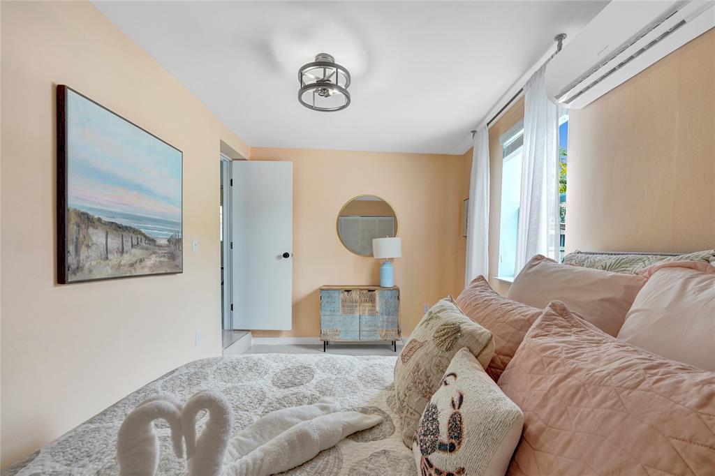 8236 Northwest 1st Place, Unit 2 Miami, FL 33150 - Photo 10 of 21 a bed sitting in a bedroom next to a window