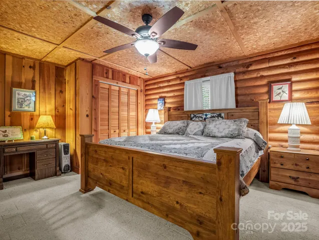 a bedroom with a large bed and a chandelier