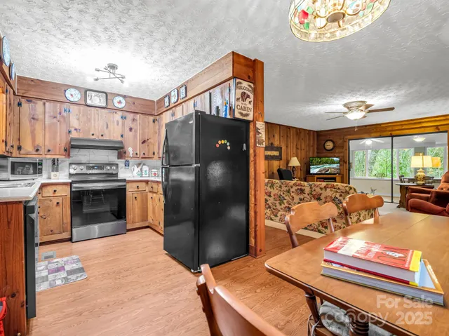 a kitchen with stainless steel appliances kitchen island granite countertop a refrigerator stove and sink