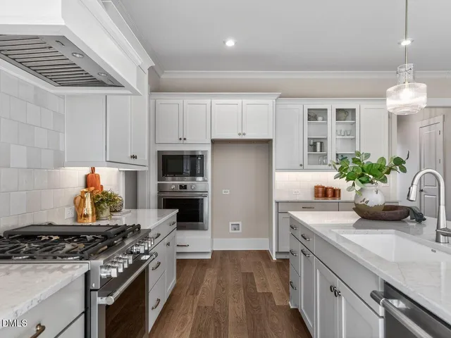 a kitchen with a white stove top oven and white cabinets