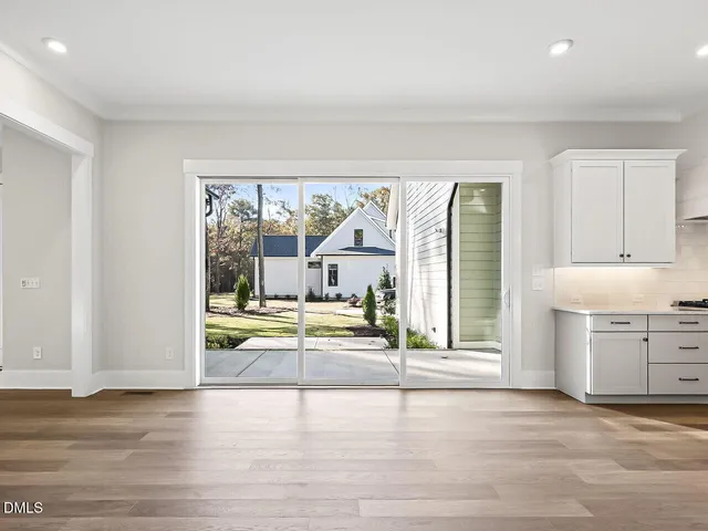 an empty room with a fireplace and large window