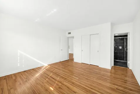a bathroom with a granite countertop sink a toilet and a mirror