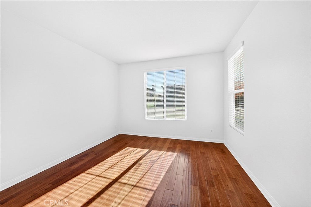 13740 Santa Maria Drive Rancho Cucamonga, CA 91739 - Photo 11 of 53 an empty room with wooden floor and windows