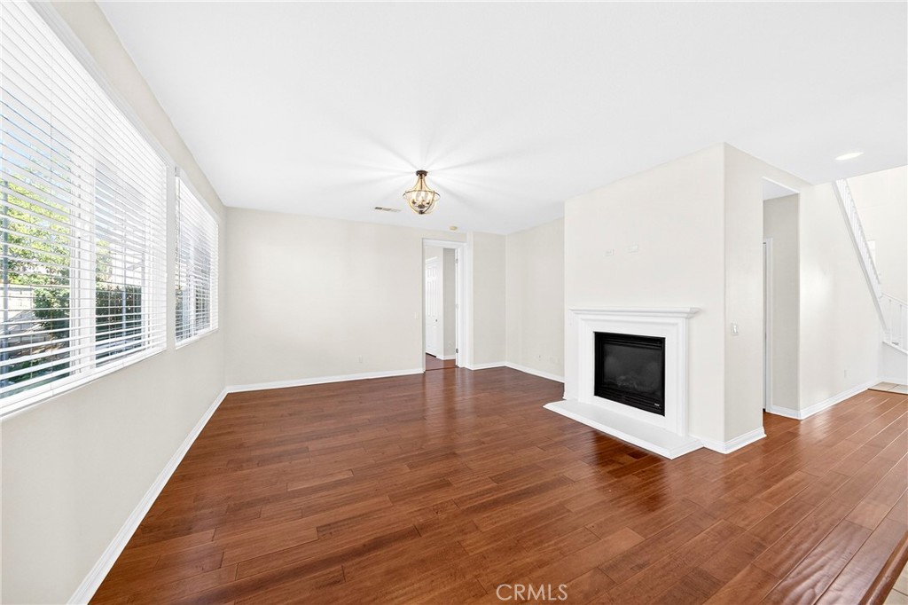 13740 Santa Maria Drive Rancho Cucamonga, CA 91739 - Photo 16 of 53 a view of empty room with wooden floor and fireplace
