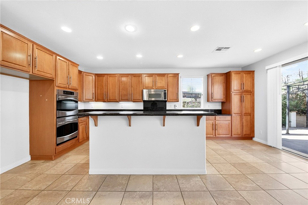 13740 Santa Maria Drive Rancho Cucamonga, CA 91739 - Photo 18 of 53 a kitchen with stainless steel appliances granite countertop a refrigerator a sink and a stove