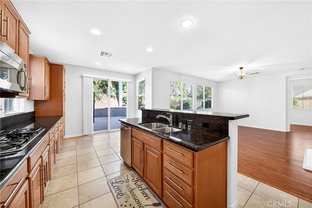13740 Santa Maria Drive Rancho Cucamonga, CA 91739 - Photo 21 of 53 a kitchen with stainless steel appliances granite countertop a stove a sink and a refrigerator