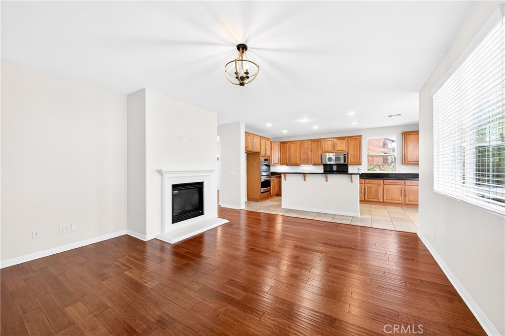 13740 Santa Maria Drive Rancho Cucamonga, CA 91739 - Photo 23 of 53 a view of a big room with wooden floor and a kitchen