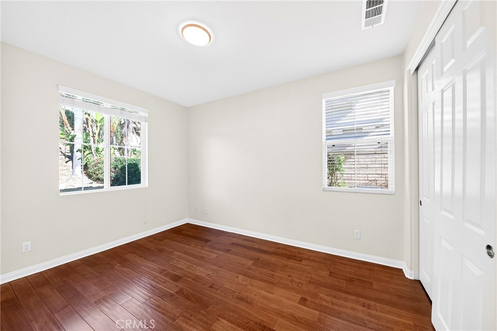 13740 Santa Maria Drive Rancho Cucamonga, CA 91739 - Photo 24 of 53 an empty room with wooden floor and windows