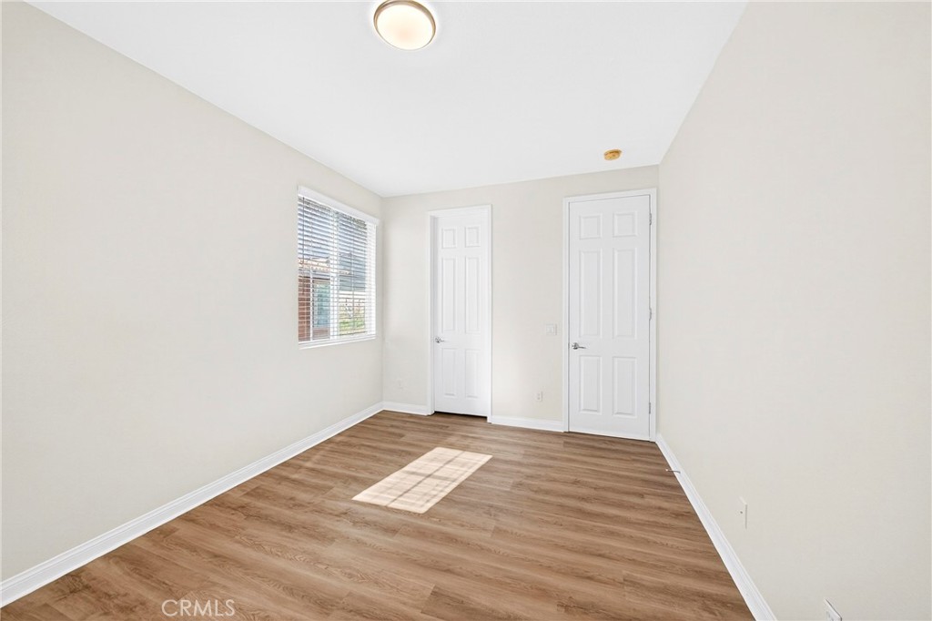 13740 Santa Maria Drive Rancho Cucamonga, CA 91739 - Photo 30 of 53 a view of a room with wooden floor and white walls