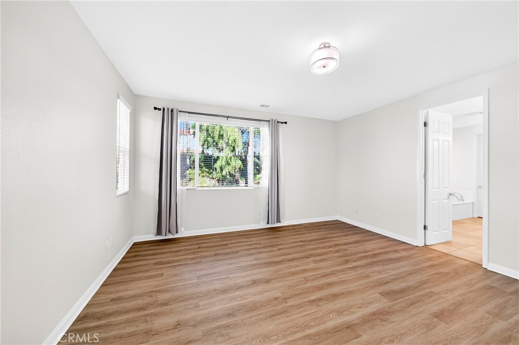 13740 Santa Maria Drive Rancho Cucamonga, CA 91739 - Photo 33 of 53 a view of an empty room with wooden floor and a window