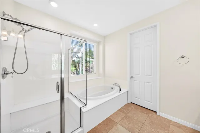 a bathroom with a bathtub and a shower