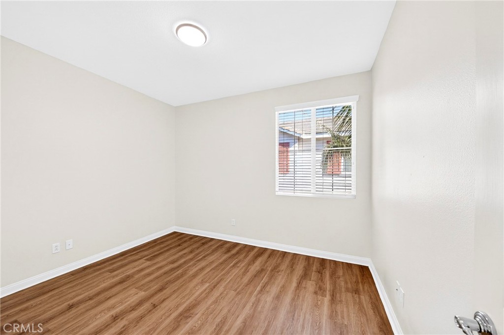 13740 Santa Maria Drive Rancho Cucamonga, CA 91739 - Photo 43 of 53 an empty room with wooden floor and windows
