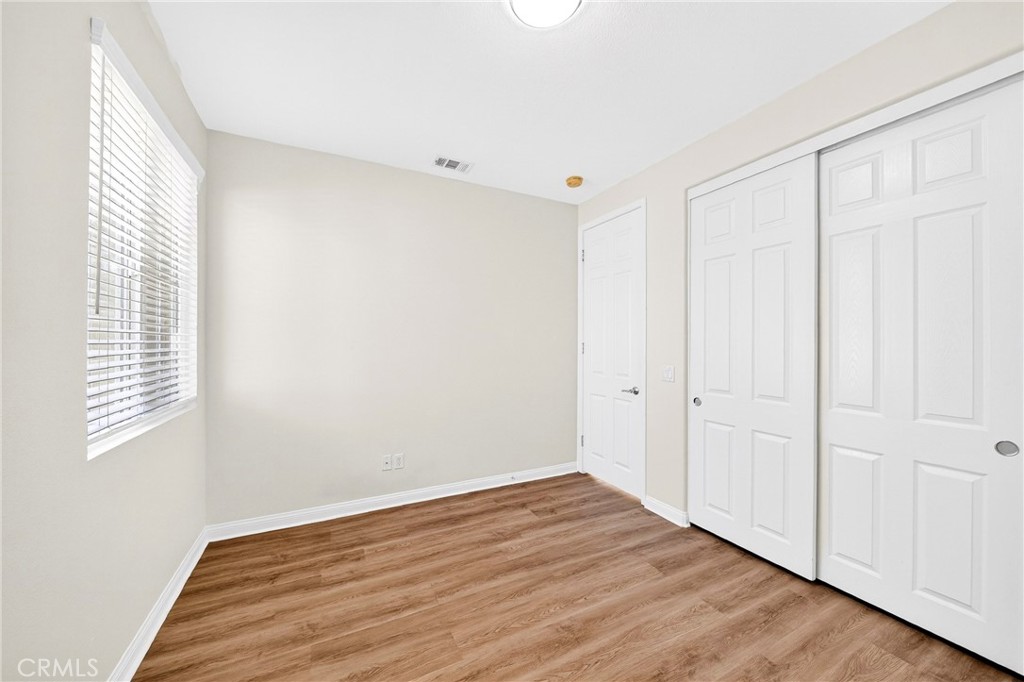 13740 Santa Maria Drive Rancho Cucamonga, CA 91739 - Photo 45 of 53 a view of an empty room with wooden floor and a window