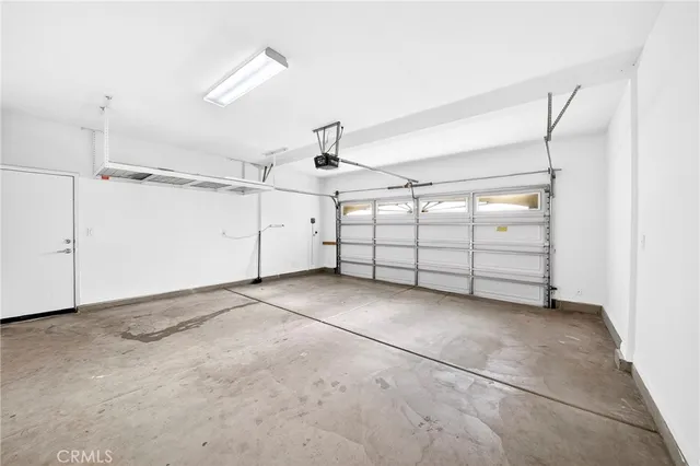 a front view of a house with a yard and potted plants