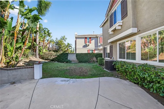 a view of house with yard and entertaining space