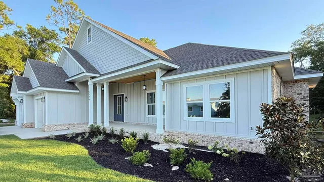a front view of a house with a garden