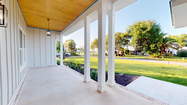 a view of a dining room with furniture a chandelier and wooden floor