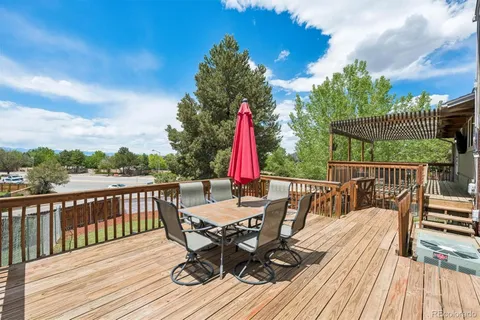 a view of a deck with furniture and wooden floor
