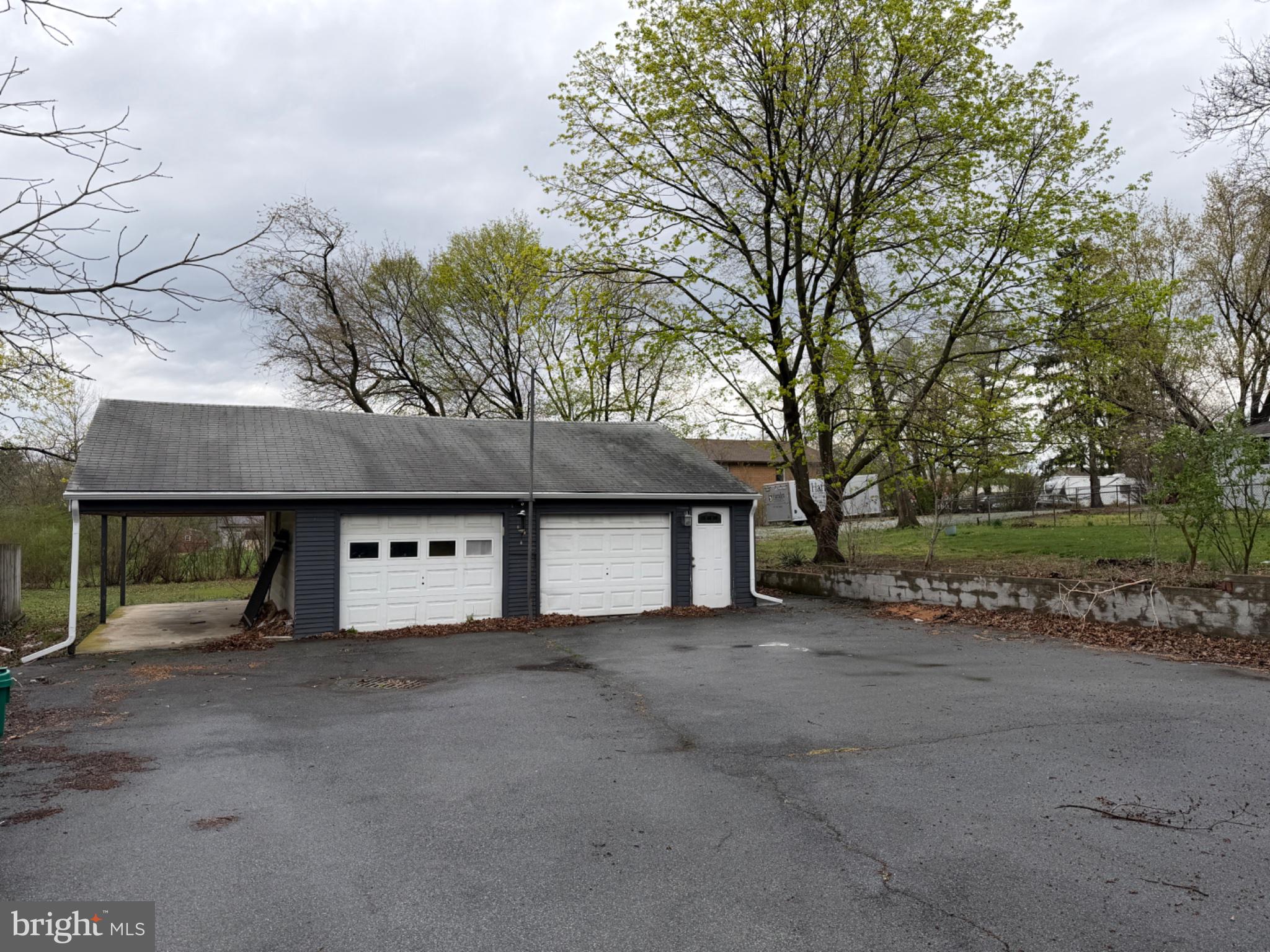7 Rutherford Road Harrisburg, PA 17109 - Photo 3 of 20 Spacious garage amid lush greenery.