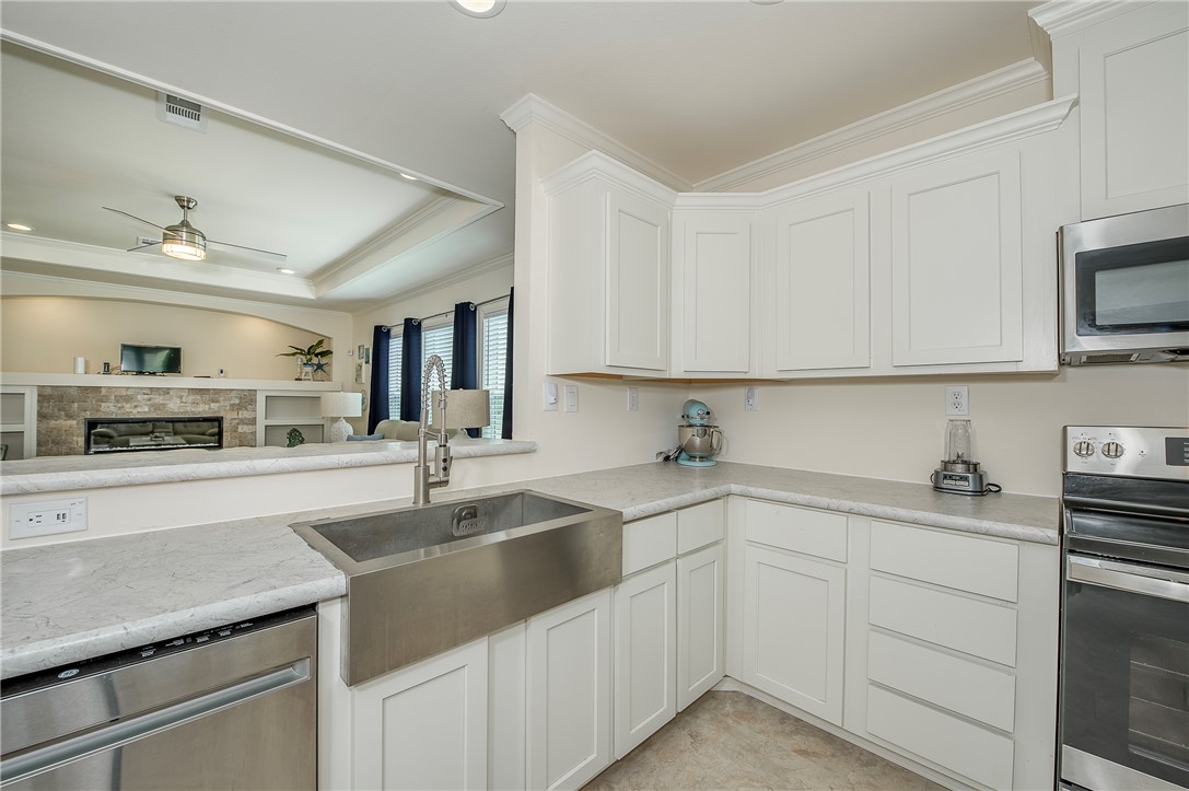10976 Whiterock Road Bremond, TX 76629 - Photo 9 of 42 a kitchen with sink cabinets and microwave