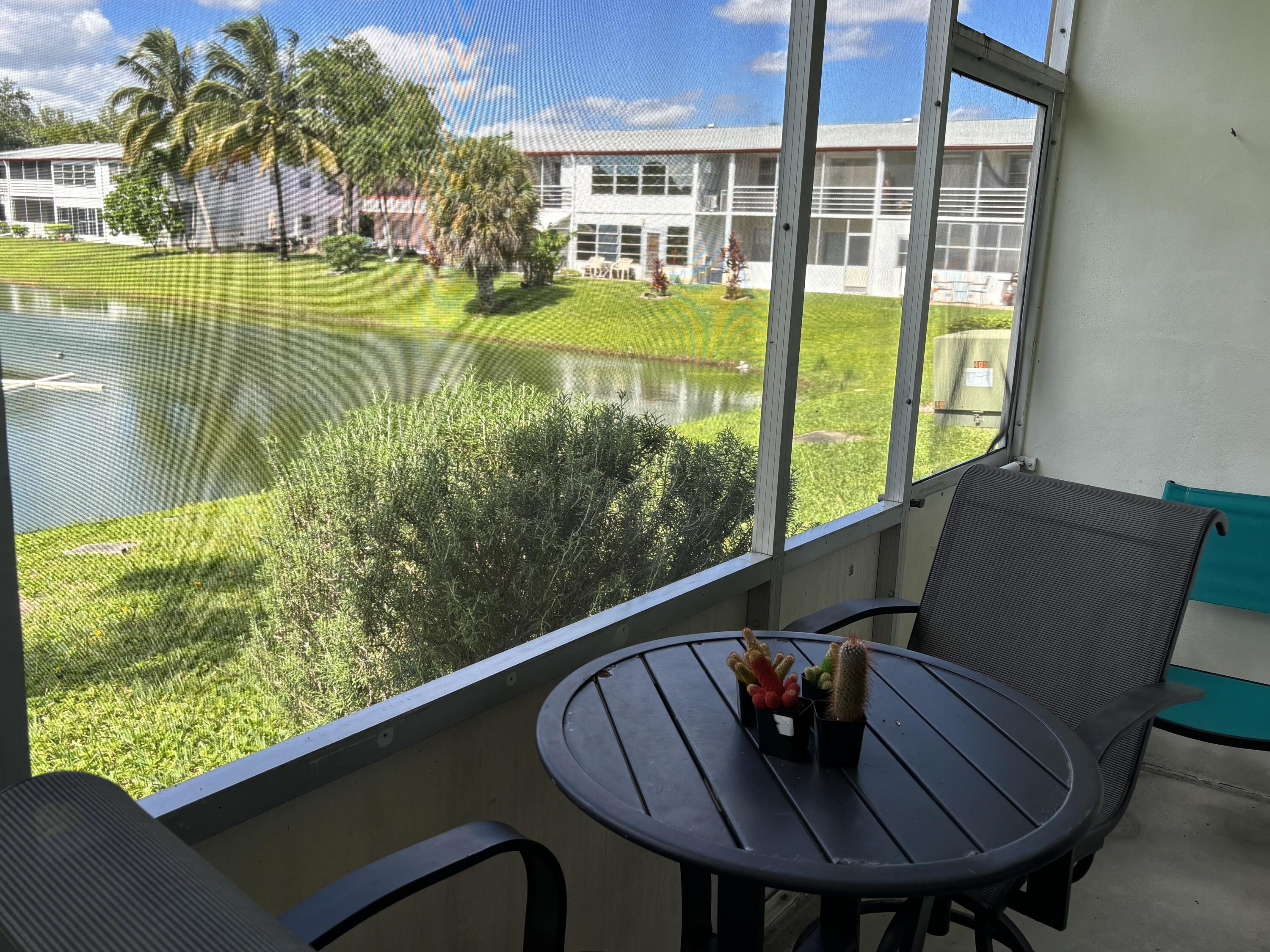 243 Northampton M, Unit 243 West Palm Beach, FL 33417 - Photo 13 of 15 a view of a chairs and table in patio