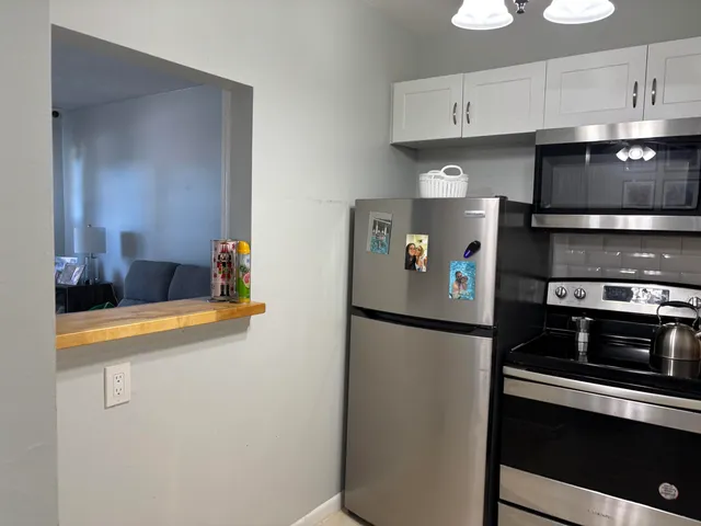 a kitchen with stainless steel appliances a refrigerator a stove and a sink