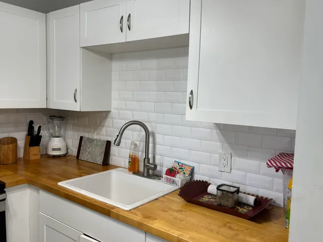 a kitchen with a sink cabinets and appliances
