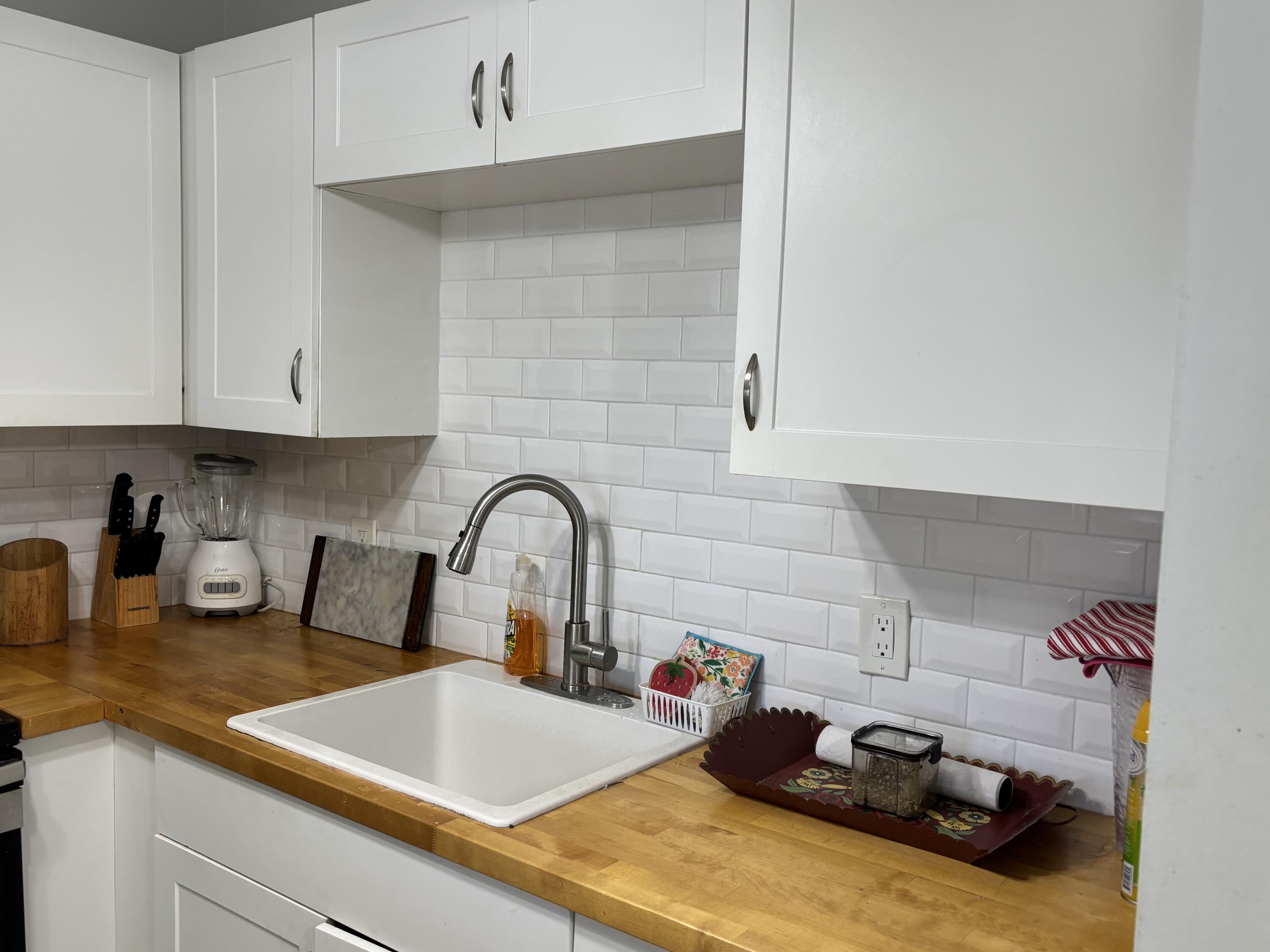 243 Northampton M, Unit 243 West Palm Beach, FL 33417 - Photo 9 of 15 a kitchen with a sink cabinets and appliances