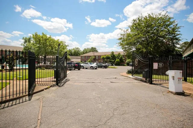 a view of a park with iron fence